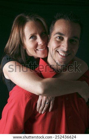 A 30 years old couple in front of black background