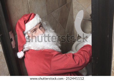 A santa claud sic in the bar toilet