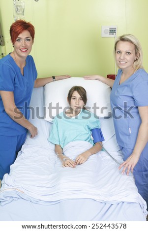 Little girl in hospital bed with the nurse