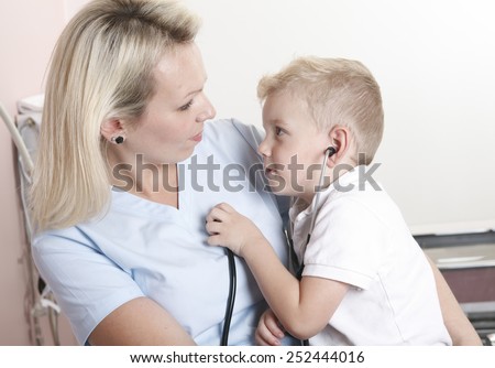 Female doctor using stethoscope to examining little sweet boy