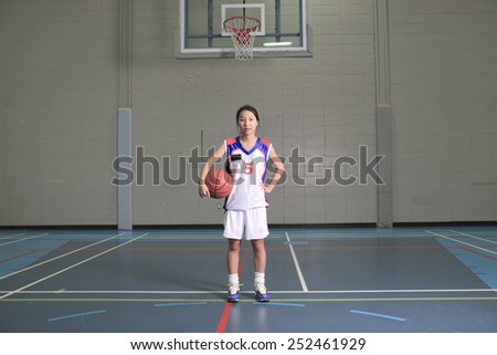 A asian basketball player in gymnase field
