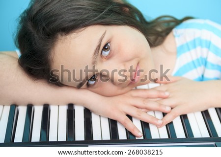 A Young girl play digital piano