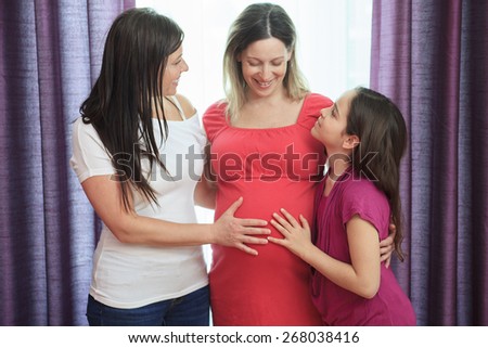 Pregnant woman and friend and child