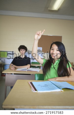 A Teenage Female Student Answering Question In Classroom