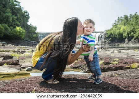 A Mother and Son Having Fun. Mom kissing her son.