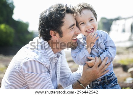 An happy joyful father having fun with is child
