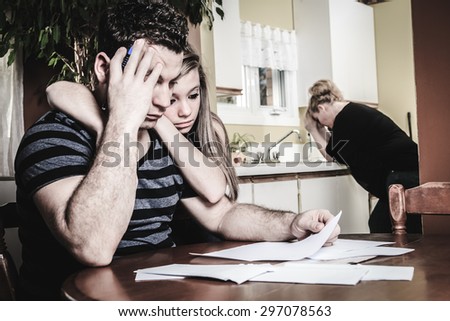 A men with financial stress at home table with teen trying to help