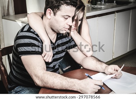 A men with financial stress at home table with teen trying to help