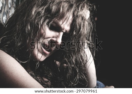A woman crying having a bad time in a tunnel