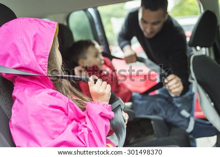 A Father worried about her children\'s safety in a car