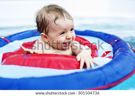 A Cute funny little toddler girl in swimming pool