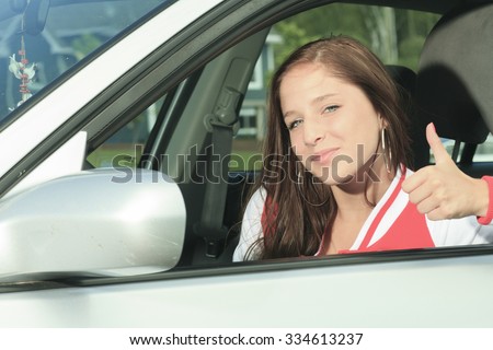A Car driver happy showing is thumb up.