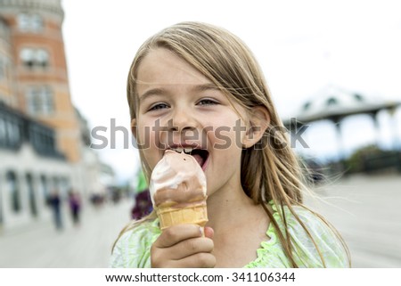 A Cute Girl Eating Ice-Cream outside on a beautuful day.