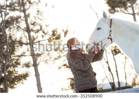 A Young  woman with horse winter sport