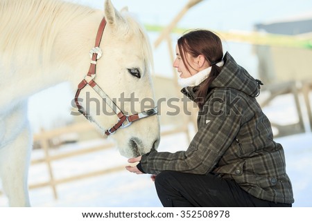 A Young  woman with horse winter sport