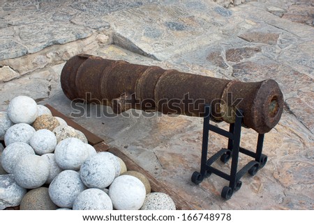 Old gun and stone cannonball in ancient fortress- museum in Marmaris, Turkey