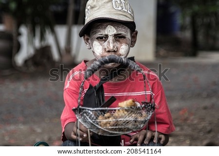 MANDALAY - MYANMAR - MAY 14, 2014: Unidentified Burmese boy on May 14, 2014 in Mandalay, Myanmar. In 2012 an ongoing conflict started between Buddhists and Muslims in Myanmar.