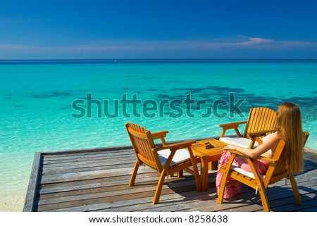 A woman sitting in the chair looking at the dreamy view on the horizon