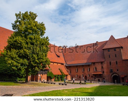 Malbork courtyard with big tree and green lawn, Poland