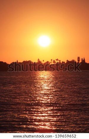 The Sun Setting, Behind a Silhouetted City, over the Intercoastal Waterway in Madeira Beach, Florida.
