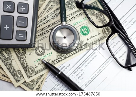 Pen stethoscope  glasses and dollar on blank Patient information