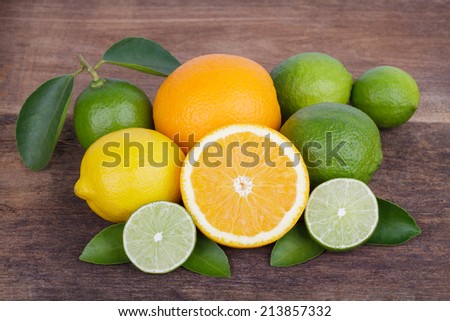 Mix of fresh citrus fruits in basket on  wood