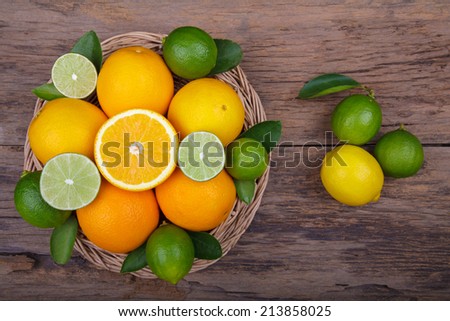 Mix of fresh citrus fruits in basket on  wood