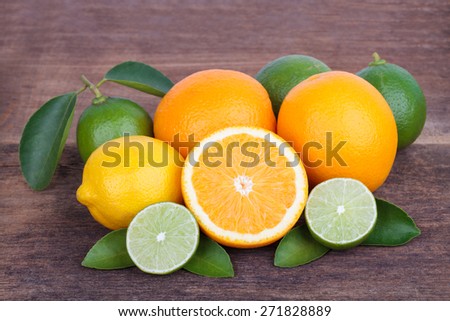 Mix of fresh citrus fruits  on wooden