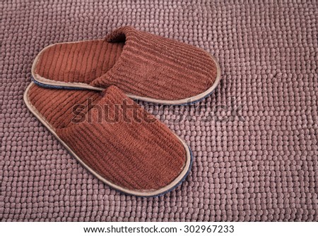 Brown wool slipper on mat
