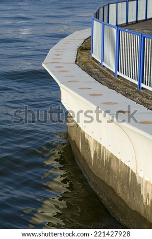 Steel Wave Protection and Railing with Calm Water Portrait