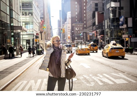 Girl calling taxi cab in New York City