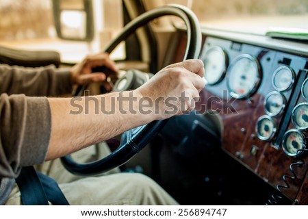 driver hands holding steering wheel