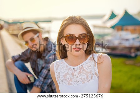 young girl and her boyfriend in the background. Young couple