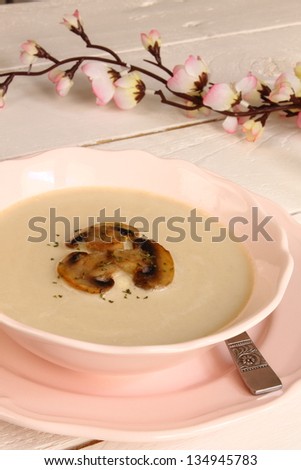 Mushroom soup in a shabby look and pink dinner service
