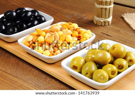 Black pitted olives, mixed nuts and stuffed green olives, a traditional aperitif