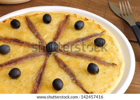 Pissaladiere, a pizza-like dish made in France and Italy with a thick bread dough, onion, garlic, anchovies and black olives