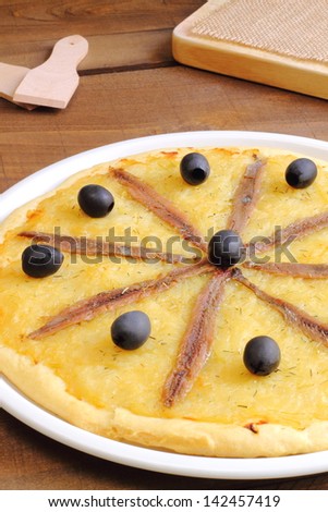 Pissaladiere, a pizza-like dish made in France and Italy with a thick bread dough, onion, garlic, anchovies and black olives