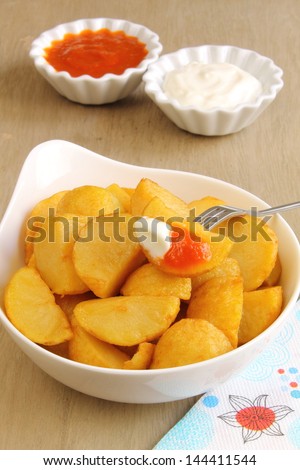 Potato wedges with two sauces, Spanish tapas called patatas bravas