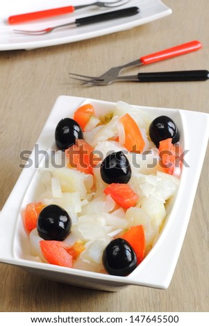 Esqueixada, a traditional Catalan salad with shredded salt cod, tomatoes, onions and black olives