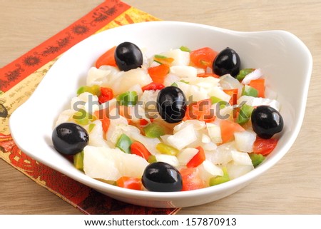 Cod salad with shredded salt cod, tomatoes, bell peppers, onions and black olives, a traditional Spanish dish from the region of Catalonia