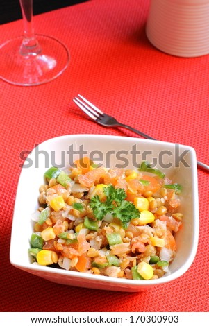 Healthy lentil salad with tuna, tomatoes, onions, green bell peppers and corn