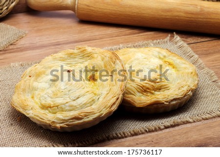 Meat pies filled with veal meat, ham, chorizo sausage, bacon, tomatoes, green peppers and boiled eggs. Traditional Murcian meat pie named \