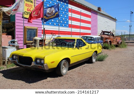 SELIGMAN, ARIZONA - AUGUST 16, 2014: Old cars parked on the Mother Road, on August 16, 2014 in Seligman, AZ. Seligman is famous as origin of Route 66 and inspiration for the town of the movie Cars.
