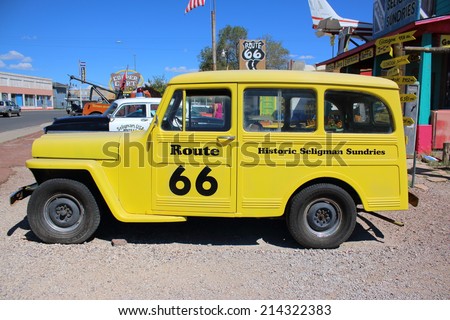 SELIGMAN, ARIZONA - AUGUST 16, 2014: Old yellow car parked on the Mother Road, on August 16, 2014 in Seligman, AZ. Seligman is famous as origin of Route 66 and inspiration for the town of movie Cars.