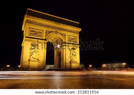 The Arc de Triomphe Paris illuminated by night, the most monumental of all triumphal arches. The Arch of Triumph is in honor of those who fought for France during the Napoleonic Wars. Long exposure.