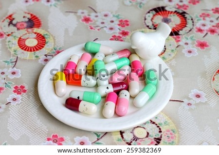 Colorful capsules with happy faces