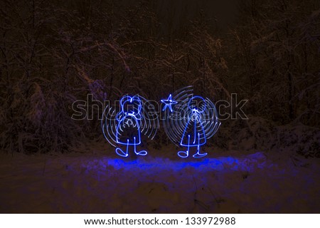 Painting with light image of boy and girl angels