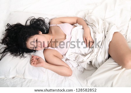 smiling asian sexy young woman sleeping on bed