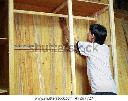 man working on wood furniture