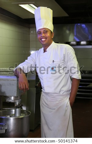 pastry chef standing next by nixer machine